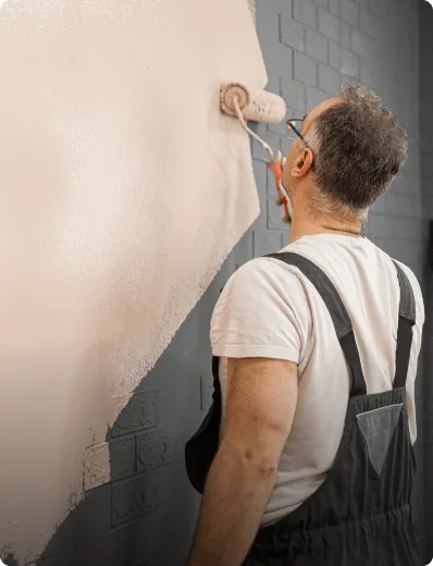 Decorator painting an interior wall in a Bournemouth home