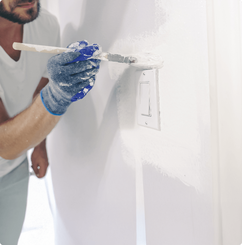 Professional painter and decorator in Bournemouth painting an interior wall