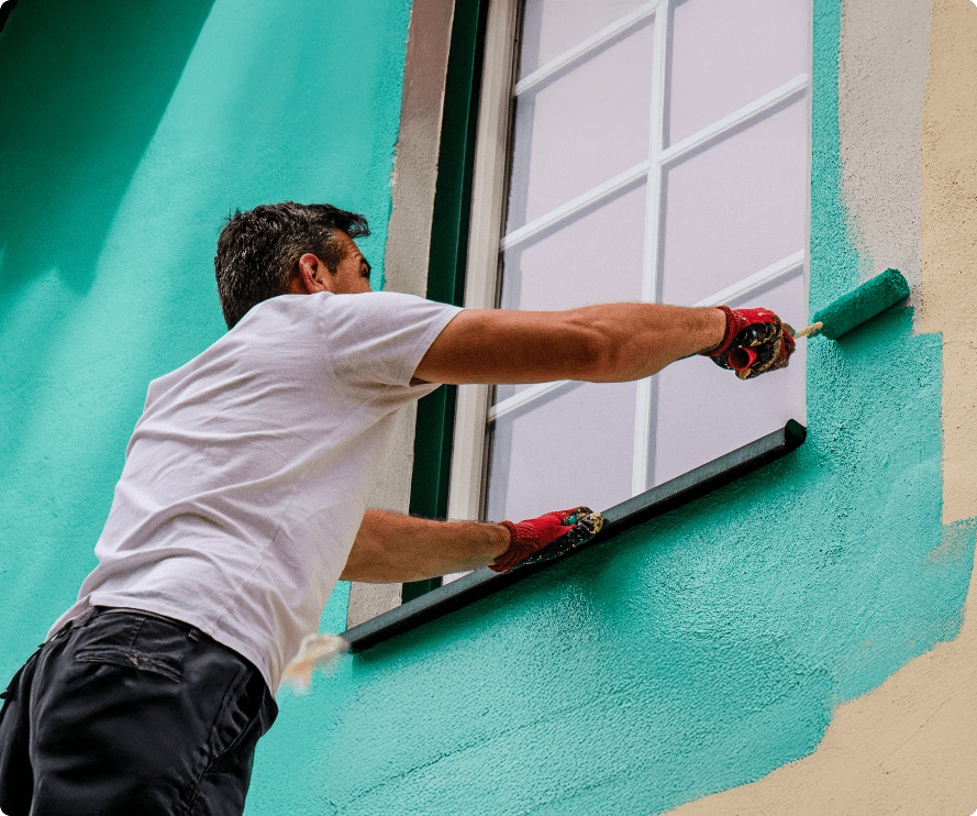 Painter and decorator in Bournemouth painting an exterior house wall