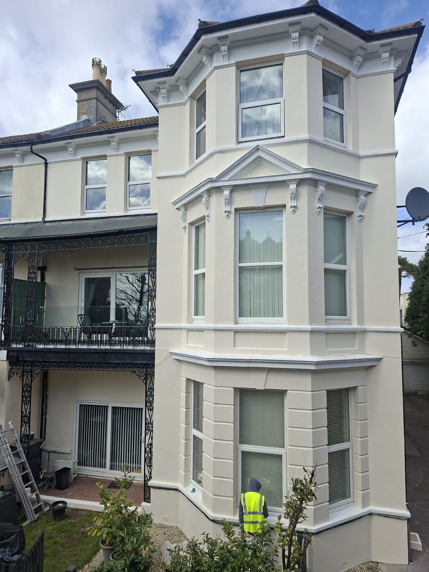 Completed exterior painting and decorating project on a large block of flats in Boscombe with restored masonry walls, painted bay windows, balcony railings, and clean exterior finish.